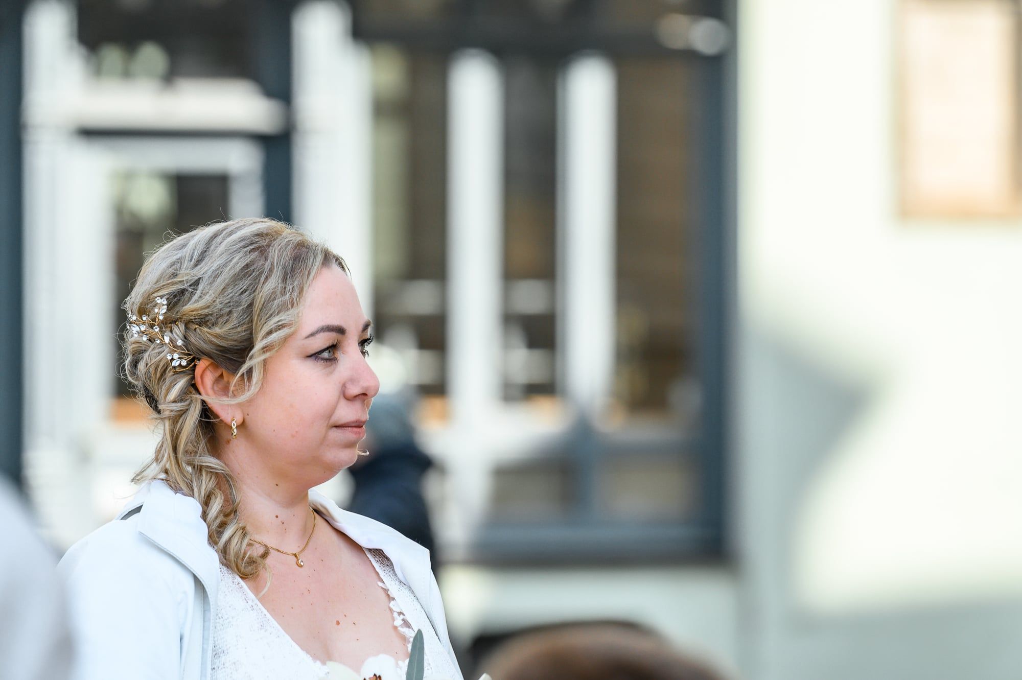 Braut mit hochgesteckten Haaren blickt im Profil zur Seite – Hochzeit in Augsburg